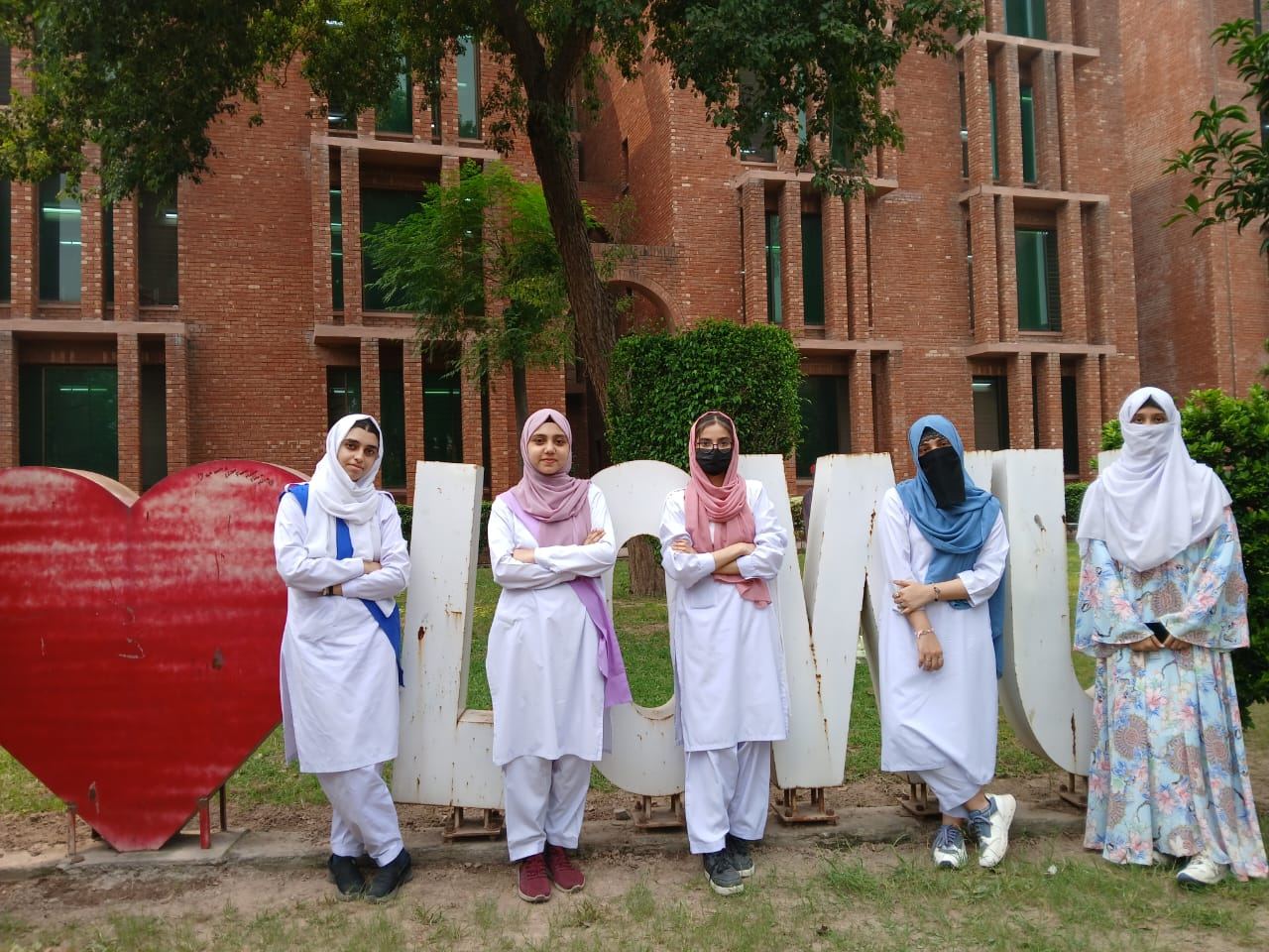 Students posing outside a university building