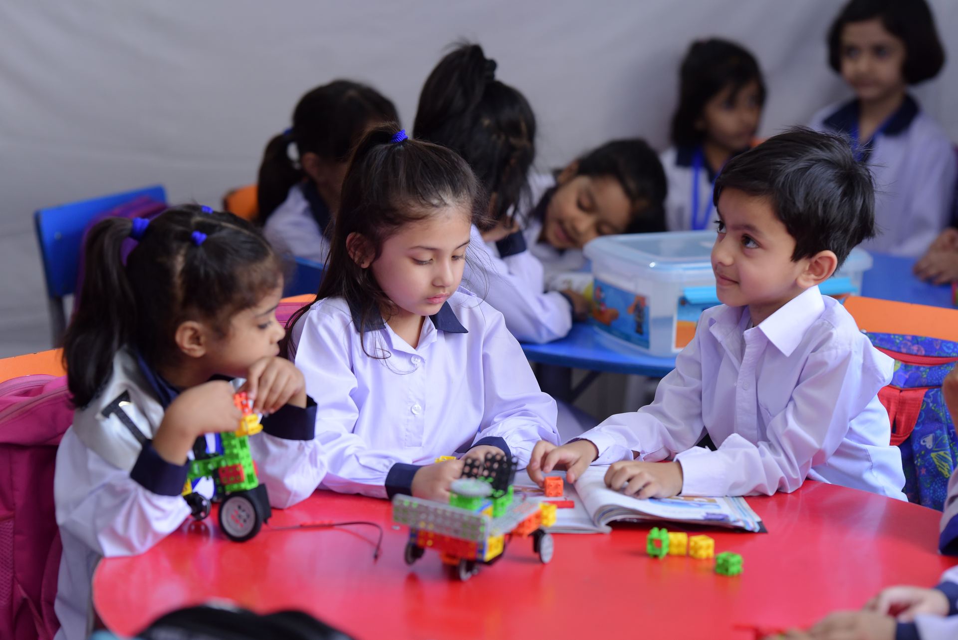 Young children building with robotics blocks